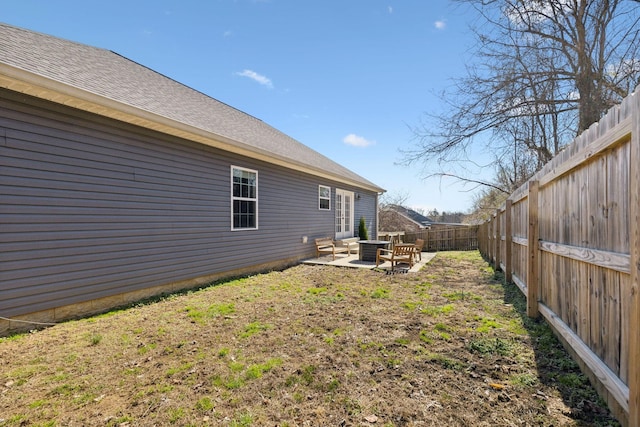 view of yard with central AC unit, a patio area, and a fenced backyard