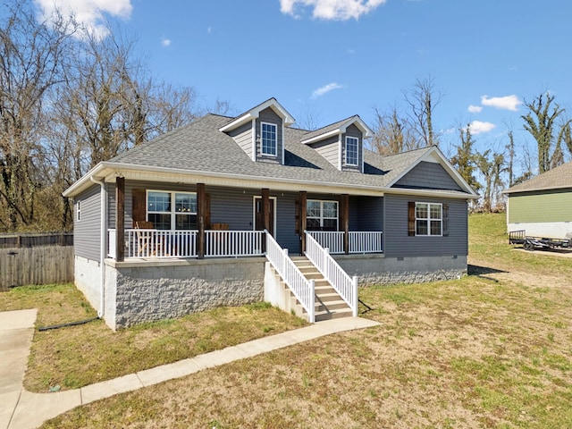 view of front facade with a porch, a shingled roof, crawl space, stairway, and a front lawn