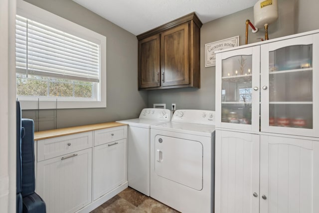 laundry area featuring cabinet space and washing machine and clothes dryer