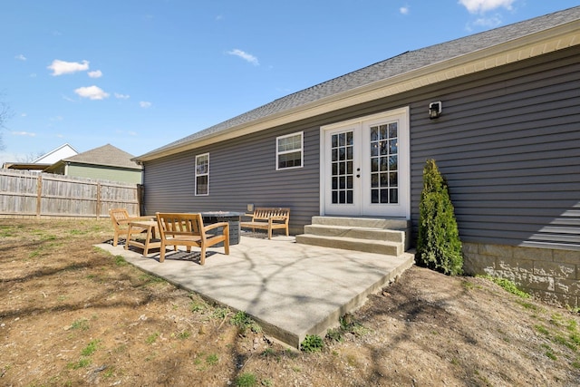 rear view of property with french doors, fence, and a patio