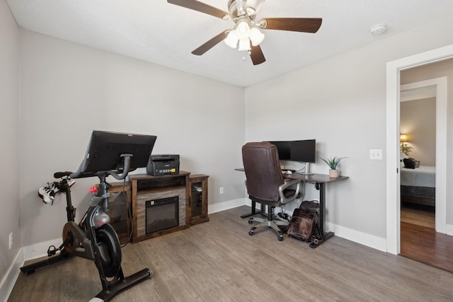 office space with ceiling fan, baseboards, and wood finished floors