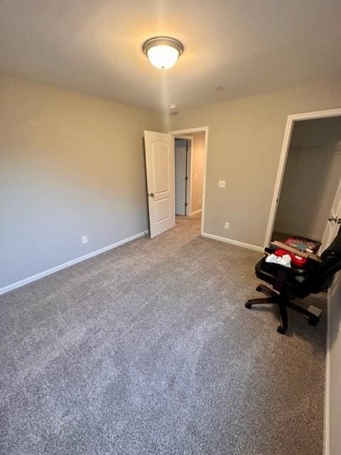 unfurnished bedroom with carpet flooring and baseboards