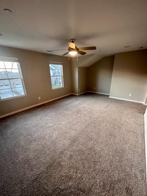 empty room with carpet floors, baseboards, and a ceiling fan