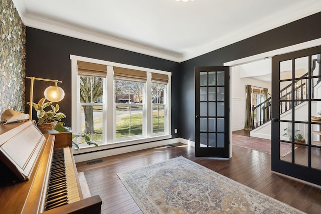 interior space featuring visible vents, ornamental molding, stairway, and hardwood / wood-style flooring