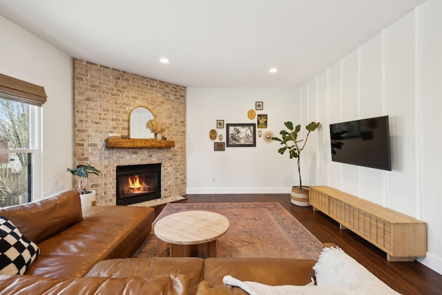 living room featuring recessed lighting, a fireplace, baseboards, and wood finished floors