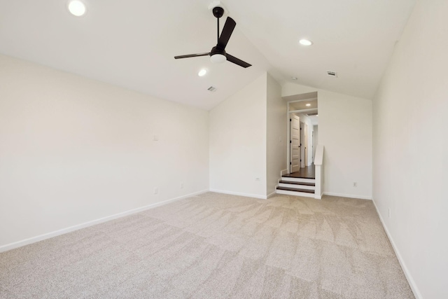 unfurnished room with lofted ceiling, recessed lighting, light colored carpet, ceiling fan, and baseboards