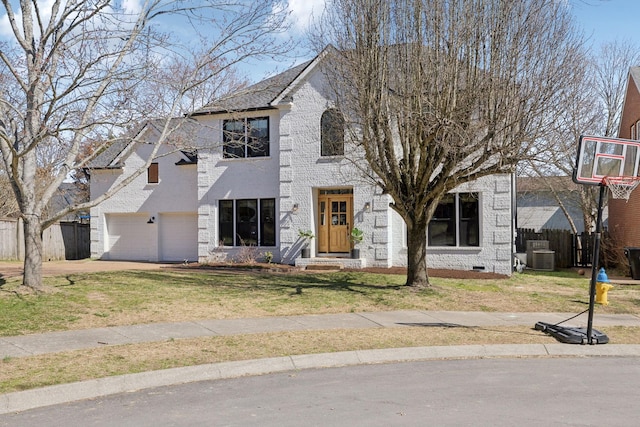 view of front of home with a garage, a front yard, brick siding, and fence