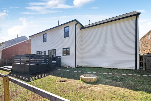 back of house featuring a fire pit, fence, a yard, crawl space, and a wooden deck