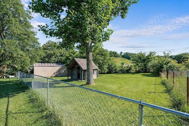 view of yard featuring an outdoor structure and fence