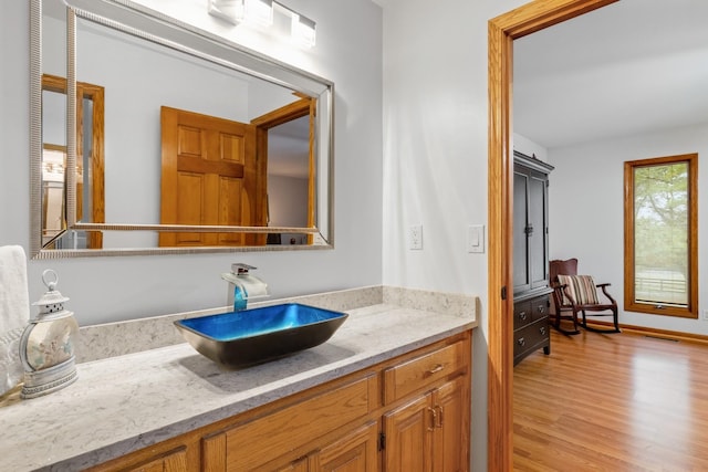 bathroom featuring visible vents, vanity, and wood finished floors