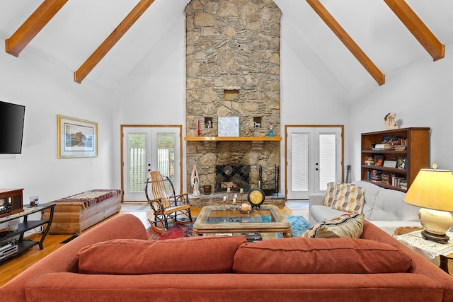 living area featuring french doors, a fireplace, beam ceiling, and wood finished floors