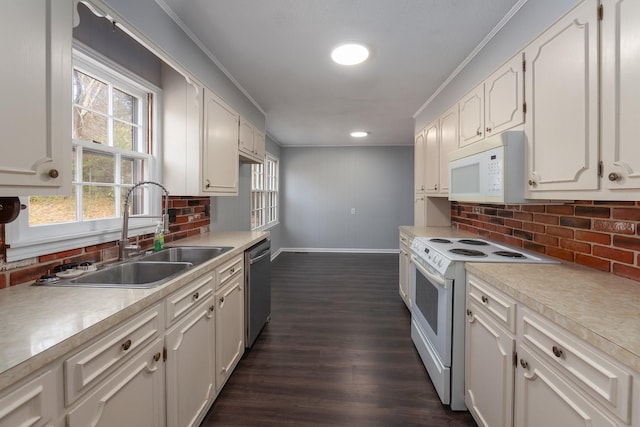 kitchen with white appliances, a sink, white cabinets, light countertops, and crown molding