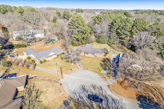 birds eye view of property featuring a view of trees