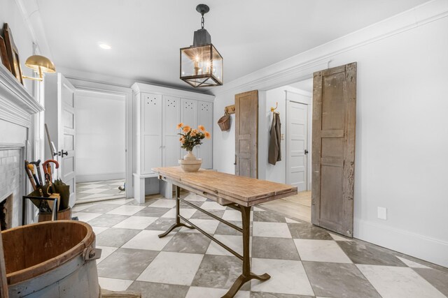 interior space with baseboards, a chandelier, and ornamental molding