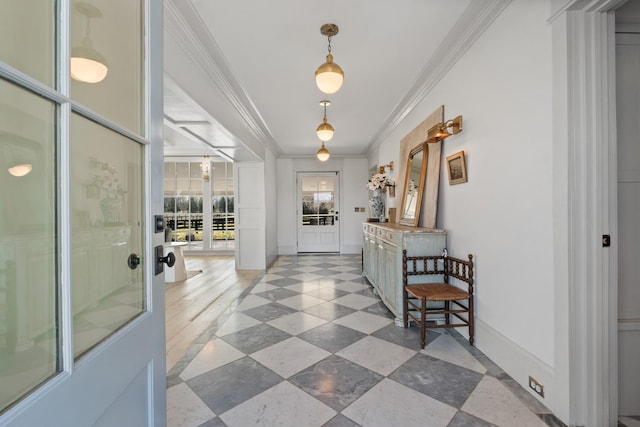 interior space with baseboards and ornamental molding