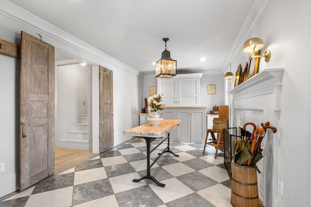 dining area with stairs, light floors, and ornamental molding