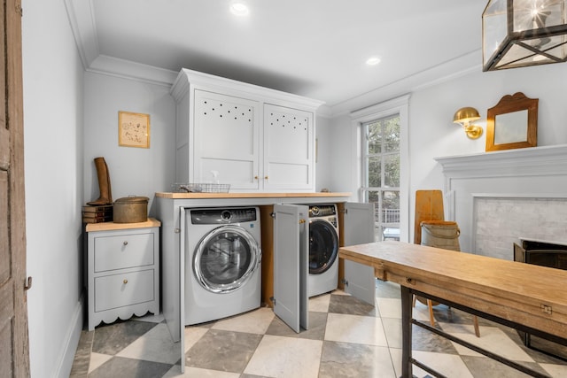 laundry area with recessed lighting, a fireplace, washer and dryer, ornamental molding, and cabinet space