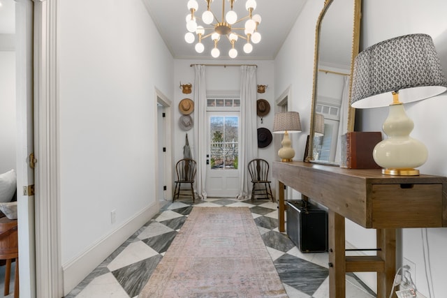 interior space featuring a notable chandelier, crown molding, and baseboards