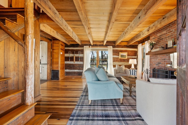 living area with wood ceiling, wooden walls, wood-type flooring, and beam ceiling