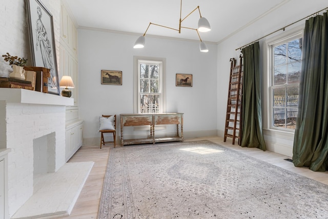 unfurnished dining area featuring ornamental molding, light wood-type flooring, and baseboards