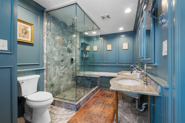 full bathroom with toilet, a decorative wall, a sink, visible vents, and a stall shower