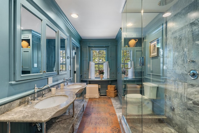 full bathroom with double vanity, a stall shower, and a sink