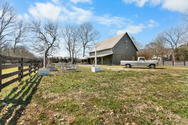 view of yard featuring fence and an outdoor structure