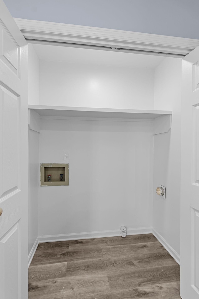 laundry room featuring laundry area, washer hookup, wood finished floors, and baseboards