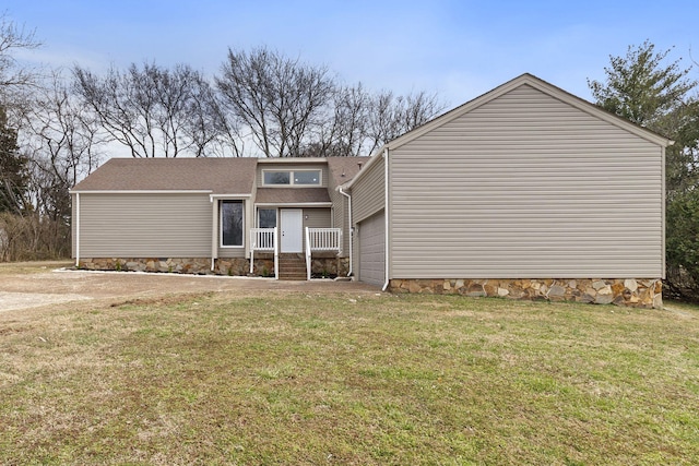 view of front facade with a garage, crawl space, and a front lawn