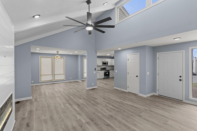 unfurnished living room with light wood-style flooring, baseboards, and ceiling fan