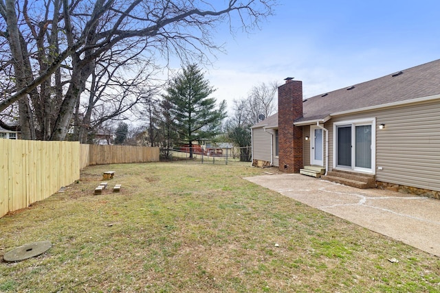 view of yard featuring entry steps, a patio area, and a fenced backyard