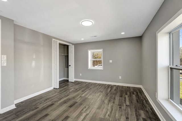 spare room featuring visible vents, baseboards, dark wood finished floors, and recessed lighting