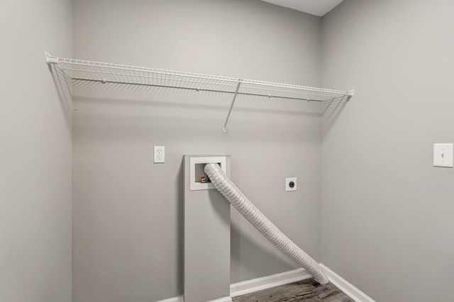 clothes washing area featuring laundry area, baseboards, wood finished floors, washer hookup, and electric dryer hookup