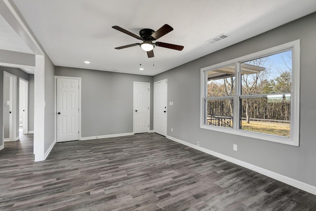 empty room with visible vents, baseboards, dark wood finished floors, a ceiling fan, and recessed lighting