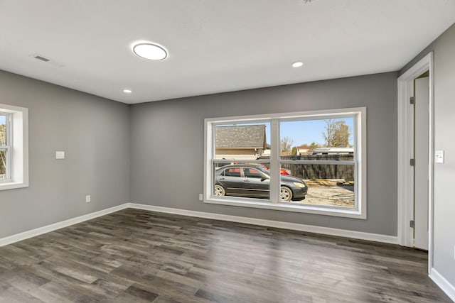 spare room with recessed lighting, visible vents, baseboards, and wood finished floors