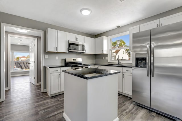 kitchen featuring a wealth of natural light, appliances with stainless steel finishes, a sink, and white cabinetry