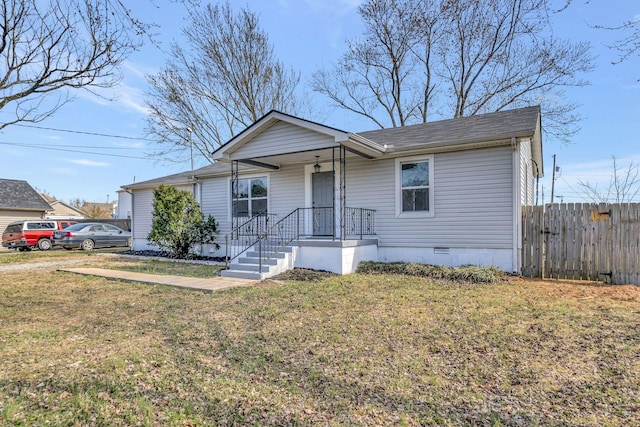 view of front of property with a front lawn, crawl space, and fence