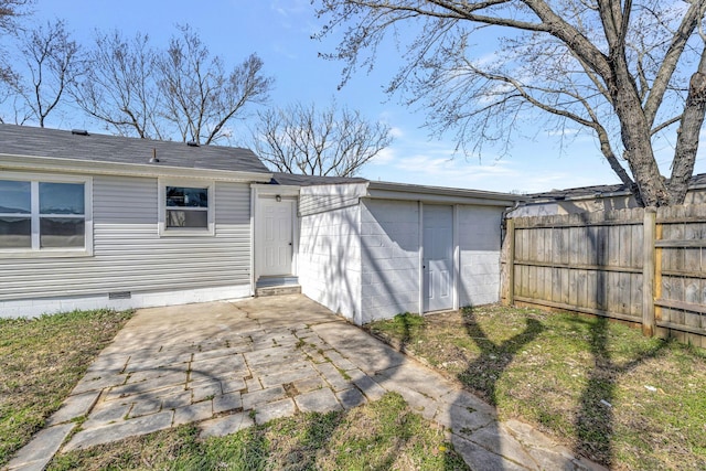 back of house featuring crawl space, fence, and a patio