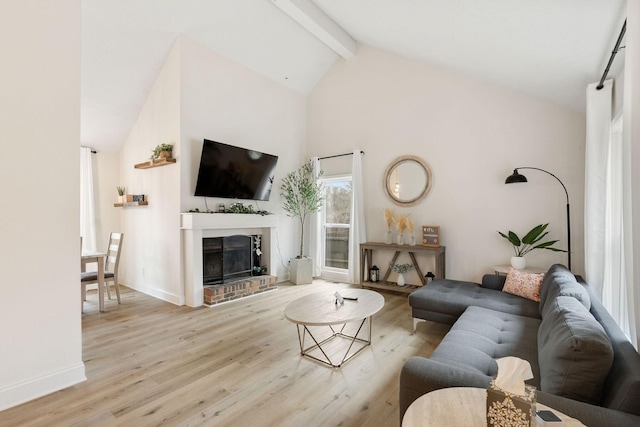 living area with a fireplace, wood finished floors, high vaulted ceiling, beamed ceiling, and baseboards