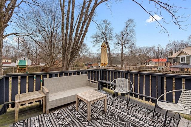 wooden deck featuring a residential view and fence