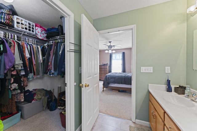 104 Allen St, Alexandria, TN 37012 - bathroom featuring tile patterned flooring, vanity, a textured ceiling, and a spacious closet