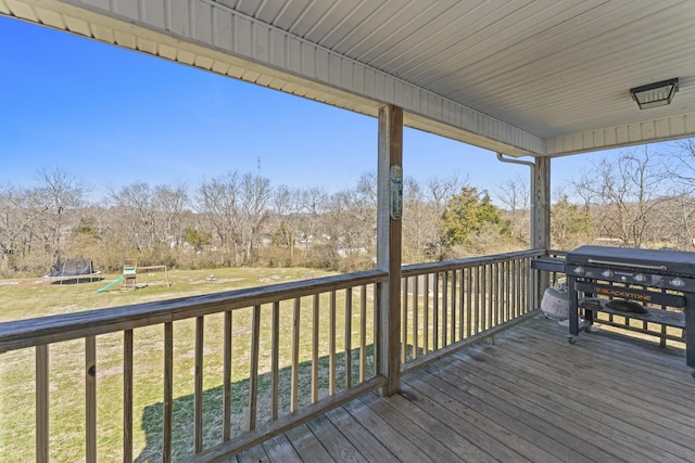 104 Allen St, Alexandria, TN 37012 - wooden deck featuring a trampoline, a grill, a playground, and a lawn