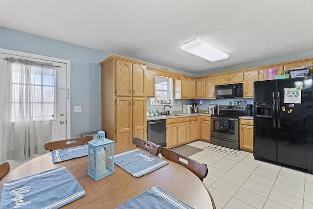 104 Allen St, Alexandria, TN 37012 - kitchen with light tile patterned floors, light countertops, black appliances, light brown cabinets, and a sink