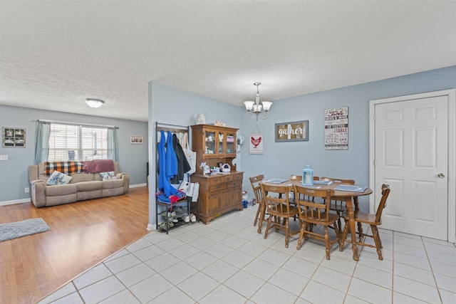 104 Allen St, Alexandria, TN 37012 - dining room featuring a chandelier, baseboards, light wood-style flooring, and a textured ceiling