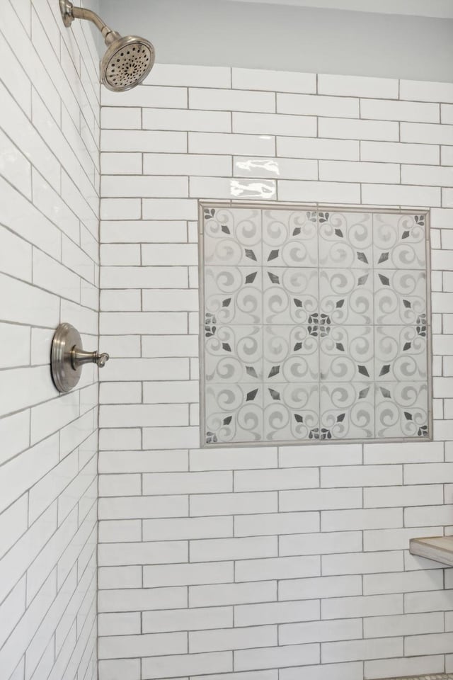 interior details with tiled shower and a gate