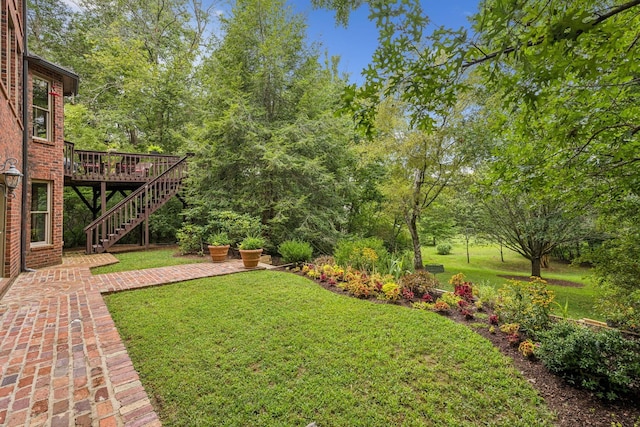 view of yard featuring stairs, a patio area, and a wooden deck