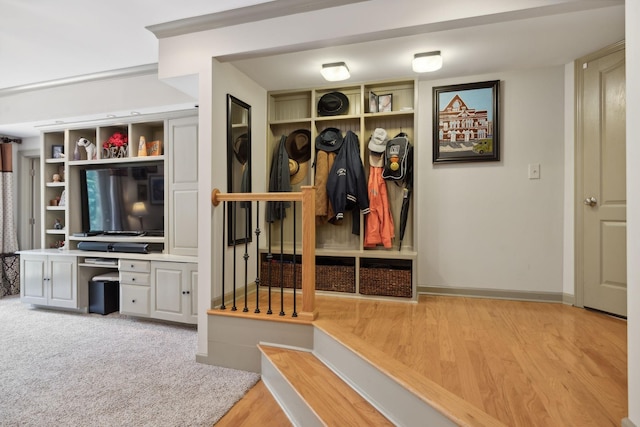 mudroom with wood finished floors, built in study area, and baseboards