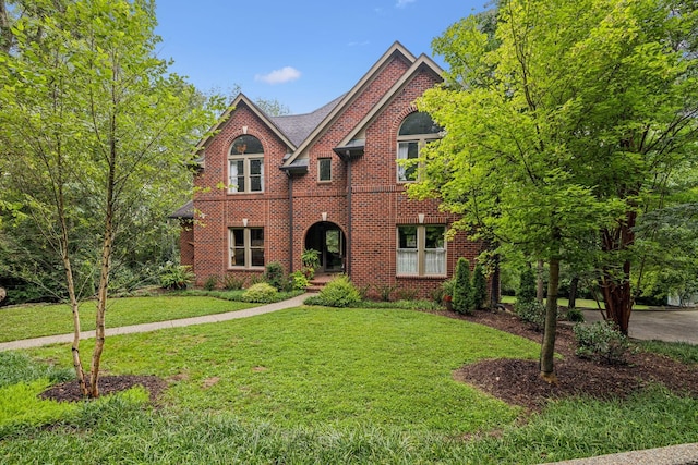 view of front of house featuring a front yard and brick siding