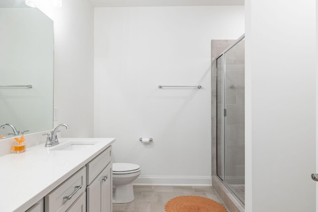 full bathroom featuring baseboards, toilet, tile patterned floors, vanity, and a shower stall