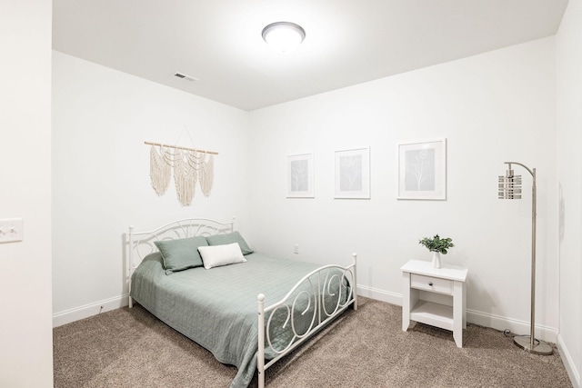 carpeted bedroom featuring baseboards and visible vents